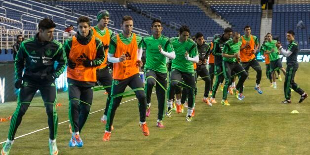SAN ANTONIO, TX - JANUARY 28: Players of Mexico stretch during a training session at Alamo dome on January 28, 2014 in San Antonio, Texas. The team is preparing to face Korea in a friendly match prior the FIFA World Cup Brazil 2014. (Photo by Miguel Tovar/LatinContent/Getty Images)