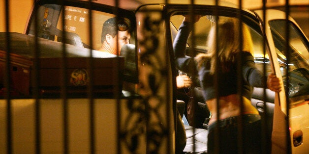 POMONA, CA - NOVEMBER 12: A man stops to talk to a female police officer posing as a prostitute on Holt Boulevard, known to sex workers throughout southern California as 'the track', during a major prostitution sting operation November 12, 2004 in Pomona, California. Approximately 60 to 80 men are arrested each night during the sting operations. Cars driven by the arrested men are seized and become city property until a $1000 fine is paid. Each vehicle is then labeled with a large window sticker stating that the car was ?seized for solicitation of prostitution? and the photos of the men appear in a full-page ad in the local newspaper. (Photo by David McNew/Getty Images)