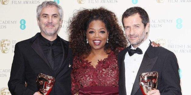 LONDON, ENGLAND - FEBRUARY 16: Oprah Winfrey poses with Director Alfonso Cuaron and producer David Heyman, winner of the Outstanding British Film award in the winners room at the EE British Academy Film Awards 2014 at The Royal Opera House on February 16, 2014 in London, England. (Photo by David M. Benett/Getty Images)