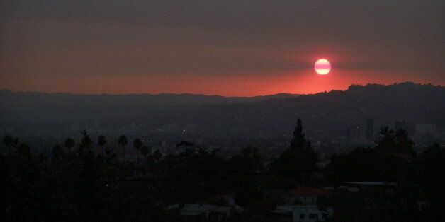 Sunset over Hollywood Hills viewed from Silver Lake through smoke from Station Fire.