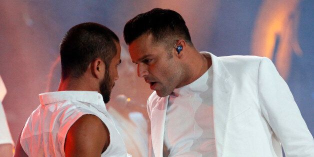 Puerto Rico's singer Ricky Martin, right, performs at the Vina del Mar International Song Festival in Vina del Mar, Chile, Sunday, Feb. 23, 2014. Believed to be one of the largest musical events in Latin America, the annual weeklong festival was inaugurated in 1960. (AP Photo/Luis Hidalgo)