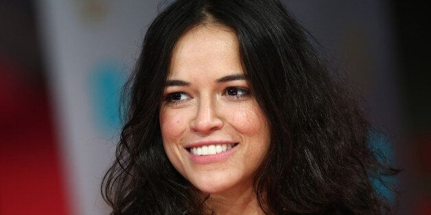 US actress Michelle Rodriguez arrives on the red carpet for the BAFTA British Academy Film Awards at the Royal Opera House in London on February 16, 2014. AFP PHOTO / ANDREW COWIE (Photo credit should read ANDREW COWIE/AFP/Getty Images)