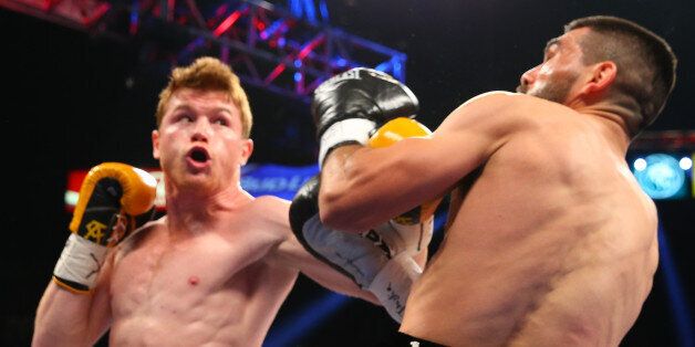 LAS VEGAS, NV - MARCH 8: Saul 'Canelo' Alvarez (yellow/black trunks) and Alfredo Angulo (black/silver trunks) during their super welterweight fight at the MGM Grand Garden Arena on March 8, 2014 in Las Vegas, Nevada. (Photo by Ed Mulholland/Golden Boy/Golden Boy via Getty Images)