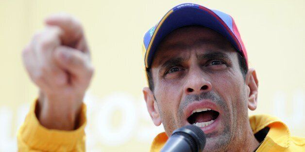 Venezuelan opposition leader Henrique Capriles gives a speech during a press conference in Caracas on February 16, 2014. Supporters and opponents of Venezuela's leftist government staged rival rallies in Caracas Saturday amid spiraling discontent at the country's stubborn inflation and shortage of basic goods. AFP PHOTO/LEO RAMIREZ (Photo credit should read LEO RAMIREZ/AFP/Getty Images)