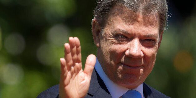 Colombian President Juan Manuel Santos waves at the press in Vina Del Mar, Chile on March 11, 2014 after Chilean President Michelle Bachelet's inauguration. Socialist Bachelet took the oath of office as president of Chile Tuesday, returning to power after four years with a reform agenda to reduce social disparities in this prosperous South American country. AFP PHOTO/Claudio Reyes (Photo credit should read Claudio Reyes/AFP/Getty Images)