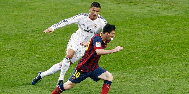 Barcelona's Argentinian forward Lionel Messi (R) vies with Real Madrid's Portuguese forward Cristiano Ronaldo during the Spanish league Clasico football match FC Barcelona vs Real Madrid CF at the Camp Nou stadium in Barcelona on October 26, 2013. AFP PHOTO/ QUIQUE GARCIA (Photo credit should read QUIQUE GARCIA/AFP/Getty Images)
