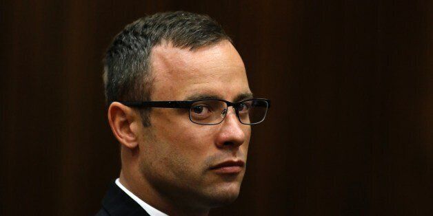 Paralympic track star Oscar Pistorius sits in the dock during his trial for the murder of his girlfriend Reeva Steenkamp, at the North Gauteng High Court in Pretoria, on March 25, 2014. Oscar Pistorius's girlfriend Reeva Steenkamp told the athlete she was sometimes scared of him in a text message sent less than three weeks before he shot her dead, his murder trial heard Thursday. 'I'm scared of you sometimes and how you snap at me and how you react to me,' Steenkamp said via messaging service WhatsApp after the athlete apparently created a scene thinking that she had flirted with another man. AFP PHOTO / POOL - SIPHIWE SIBEKO (Photo credit should read SIPHIWE SIBEKO/AFP/Getty Images)