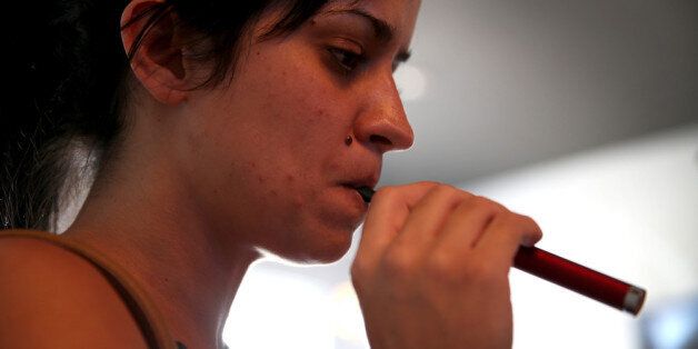 MIAMI, FL - FEBRUARY 20: Yenisley Dieppa tries different flavors as she purchases an electronic cigarette at the Vapor Shark store on February 20, 2014 in Miami, Florida. As the popularity of E- cigarettes continue to grow, leading U.S. tobacco companies such as Altria Group Inc. the maker of Marlboro cigarettes are annoucing plans to launch their own e-cigarettes as they start to pose a small but growing competitive threat to traditional smokes. (Photo by Joe Raedle/Getty Images)