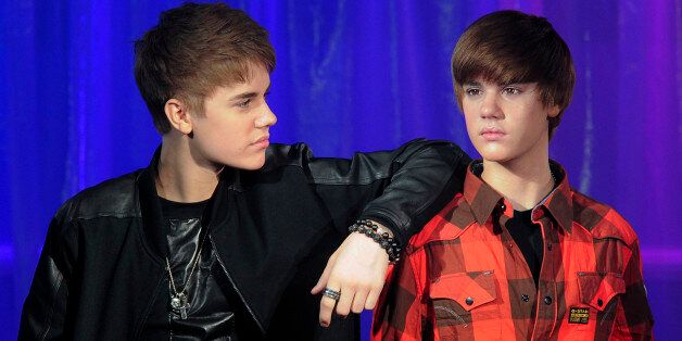 Canadian popstar Justin Bieber (L) poses with his waxwork model as it is unveiled at Madame Tussauds museum in central London, on March 15, 2011. AFP PHOTO/CARL COURT (Photo credit should read CARL COURT/AFP/Getty Images)