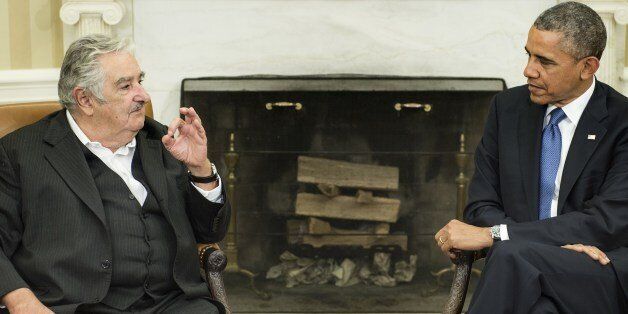 US President Barack Obama (R) listens while Uruguay President Jose Mujica Cordano makes a statement for the press before a meeting in the Oval Office of the White House May 12, 2014 in Washington, DC. AFP PHOTO/Brendan SMIALOWSKI (Photo credit should read BRENDAN SMIALOWSKI/AFP/Getty Images)