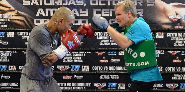 HOLLYWOOD, CA - SEPTEMBER 18: Miguel Cotto spars with trainer Freddie Roach in training for his fight against Delvin Rodriguez at Wild Card Boxing Club on September 18, 2013 in Hollywood, California. (Photo by Harry How/Getty Images)