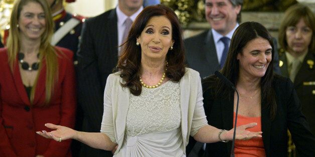 Argentina's President Cristina Fernandez de Kirchner (C) gestures after taking an oath to Security Minister Maria Rodriguez (R) at the Government House, in Buenos Aires on December 4, 2013. AFP PHOTO / Juan Mabromata (Photo credit should read JUAN MABROMATA/AFP/Getty Images)