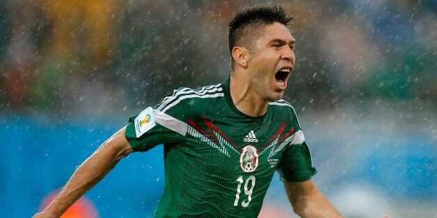 Mexico's Oribe Peralta celebrates his goal during the second half of the group A World Cup soccer match between Mexico and Cameroon in the Arena das Dunas in Natal, Brazil, Friday, June 13, 2014. (AP Photo/Eduardo Verdugo)