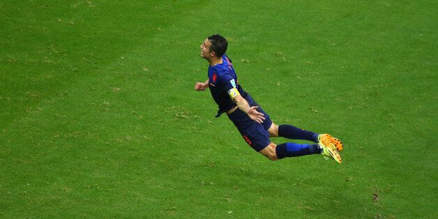 SALVADOR, BRAZIL - JUNE 13: Robin van Persie of the Netherlands scores the teams first goal with a diving header in the first half during the 2014 FIFA World Cup Brazil Group B match between Spain and Netherlands at Arena Fonte Nova on June 13, 2014 in Salvador, Brazil. (Photo by Jeff Gross/Getty Images)