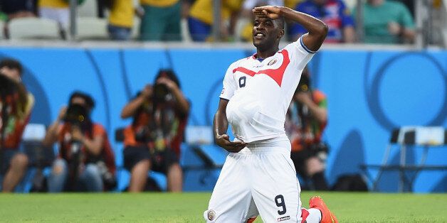 FORTALEZA, BRAZIL - JUNE 14: Joel Campbell of Costa Rica celebrates scoring his team's first goal with the ball under his jersey during the 2014 FIFA World Cup Brazil Group D match between Uruguay and Costa Rica at Castelao on June 14, 2014 in Fortaleza, Brazil. (Photo by Laurence Griffiths/Getty Images)