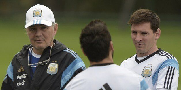 Argentina's coach Alejandro Sabella (L), forward Lionel Messi (R) and Ezequiel Lavezzi chat at the beginning of a training session at 'Cidade do Galo', their base camp in Vespasiano, near Belo Horizonte, some 470 Km north of Rio de Janeiro, Brazil on June 12, 2014 ahead their 2014 FIFA World Cup Brazil Group F football match against Bosnia and Hercegovina to be held at the Maracana Stadium in Rio de Janeiro on June 15. AFP PHOTO / Juan Mabromata (Photo credit should read JUAN MABROMATA/AFP/Getty Images)