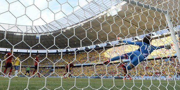 Mexico's goalkeeper Guillermo Ochoa dives for the ball during a Group A football match between Brazil and Mexico in the Castelao Stadium in Fortaleza during the 2014 FIFA World Cup on June 17, 2014. AFP PHOTO / YURI CORTEZ (Photo credit should read YURI CORTEZ/AFP/Getty Images)