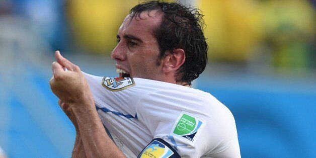Uruguay's defender Diego Godin celebrates after scoring during a Group D football match between Italy and Uruguay at the Dunas Arena in Natal during the 2014 FIFA World Cup on June 24, 2014. AFP PHOTO/ JAVIER SORIANO (Photo credit should read JAVIER SORIANO/AFP/Getty Images)