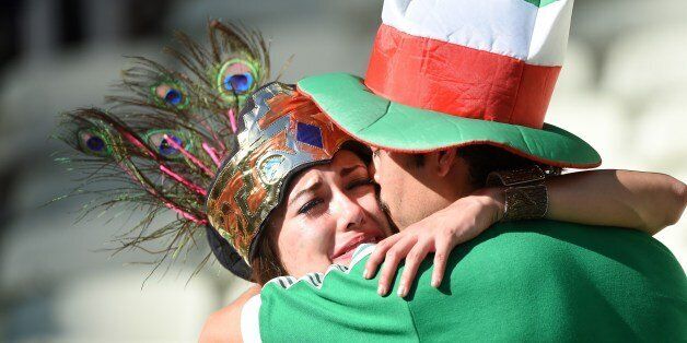 Mexican supporters react after their team's defeat in the Round of 16 football match between Netherlands and Mexico at Castelao Stadium in Fortaleza during the 2014 FIFA World Cup on June 29, 2014. AFP PHOTO / EMMANUEL DUNAND (Photo credit should read EMMANUEL DUNAND/AFP/Getty Images)
