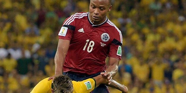 Brazil's Neymar is fouled by Colombia's Juan Zuniga during the World Cup quarterfinal soccer match between Brazil and Colombia at the Arena Castelao in Fortaleza, Brazil, Friday, July 4, 2014. (AP Photo/Manu Fernandez)