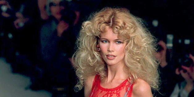PARIS, FRANCE - FEBRUARY 16: Top model Claudia Schiffer wears a transparent crimson smock with embroidered fern-leaf filligree over a pearl-gray satin slip-dress designed by Karl Lagerfeld for Chloe's Autumn-Winter 1995 ready-to-wear collection shown 16 March in Paris. (COLOR KEY: Red smock). AFP PHOTO (Photo credit should read Patrick KOVARIC/AFP/Getty Images)