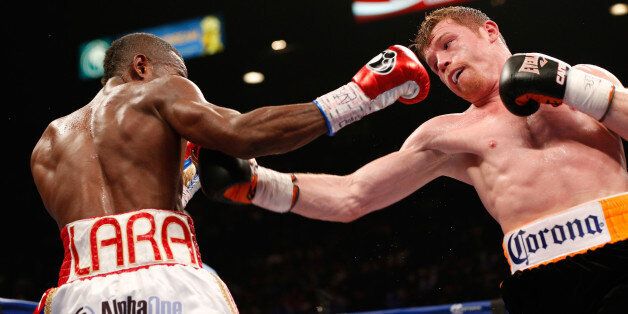 LAS VEGAS, NV - JULY 12: (R-L) Canelo Alvarez and Erislandy Lara trade punches during their junior middleweight bout at the MGM Grand Garden Arena on July 12, 2014 in Las Vegas, Nevada. (Photo by Josh Hedges/Getty Images)