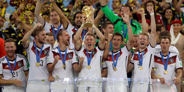 Germany's Bastian Schweinsteiger holds up the World Cup trophy as the team celebrates their 1-0 victor over Argentina after the World Cup final soccer match between Germany and Argentina at the Maracana Stadium in Rio de Janeiro, Brazil, Sunday, July 13, 2014. (AP Photo/Natacha Pisarenko)