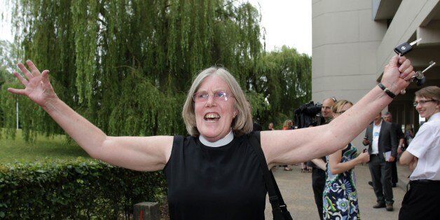 A female member of the clergy celebrates outside the venue after members voted to approve the creation of female bishops at the Church of England General Synod in York, northern England, on July 14, 2014. The Church of England overcame bitter divisions on July 14 to vote in favour of allowing female bishops for the first time in its nearly 500-year history. The decision reverses a previous shock rejection in 2012 and comes after intensive diplomacy by Archbishop of Canterbury, Justin Welby. AFP PHOTO / LINDSEY PARNABY (Photo credit should read LINDSEY PARNABY/AFP/Getty Images)