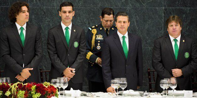 (L to R) Mexican goalkepeer Guillermo Ochoa, Mexican footballer Rafael Marquez, Mexican President Enrique Pena Nieto and Mexican football team coach Miguel Herrera take part in a dinner for the Mexican football team at the Los Pinos Residence in Mexico City, on July 15, 2014. AFP PHOTO/Alfredo ESTRELLA (Photo credit should read ALFREDO ESTRELLA/AFP/Getty Images)
