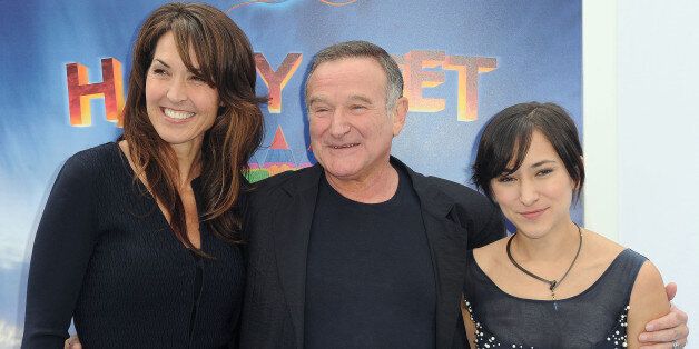 Susan Schneider, from left, Robin Williams, and Zelda Williams arrive at the premiere of "Happy Feet Two" at Grauman's Chinese Theater, Sunday, Nov. 13, 2011, in Los Angeles. "Happy Feet Two" will be released in 3D and 2D in select theaters Nov. 18, 2011. (AP Photo/Katy Winn)