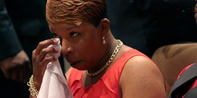 ST. LOUIS, MO - AUGUST 25: Lesley McSpadden wipes her eye during the funeral services for her son Michael Brown inside Friendly Temple Missionary Baptist Church on August 25, 2014 in St. Louis Missouri. Michael Brown, an 18 year-old unarmed teenager, was shot and killed by Ferguson Police Officer Darren Wilson in the nearby town of Ferguson, Missouri on August 9. His death caused several days of violent protests along with rioting and looting in Ferguson. (Photo by Robert Cohen-Pool/Getty Images)