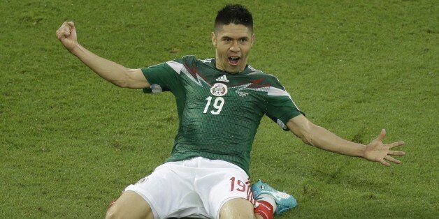 Mexico's Oribe Peralta celebrates after scoring during the group A World Cup soccer match between Mexico and Cameroon in the Arena das Dunas in Natal, Brazil, Friday, June 13, 2014. (AP Photo/Hassan Ammar)