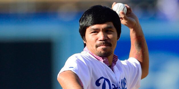 Philippine boxer Manny Pacquiao throws out the first pitch during a baseball game between the Washington Nationals and the Los Angeles Dodgers, Monday, Sept. 1, 2014, in Los Angeles. (AP Photo/Gus Ruelas)