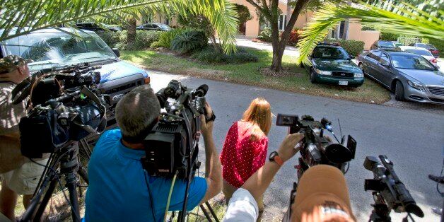 Television journalists stand across from the home of the family of journalist Steven Sotloff, Tuesday, Sept. 2, 2014 in Pinecrest, Fla. An Internet video posted online Tuesday purported to show the beheading by the Islamic State group of Sotloff, who went missing in Syria last year. In a two-sentence statement Tuesday, family spokesman Barak Barfi said Sotloff's family, quote, "knows of this horrific tragedy and is grieving privately." (AP Photo/Wilfredo Lee)