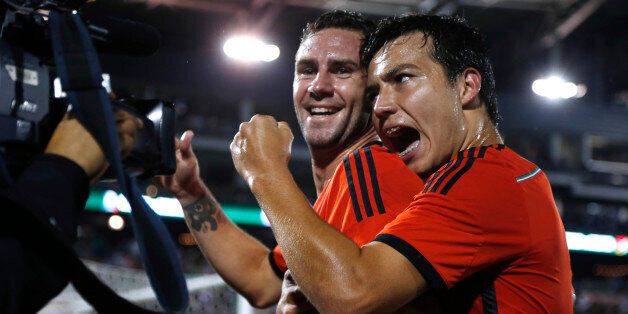 Mexico forward Erick Torres, right, celebrates with defenseman Miguel Layun after his goal against Bolivia in the first half of an international friendly soccer game in Commerce City, Colo., on Tuesday, Sept. 9, 2014. (AP Photo/David Zalubowski)