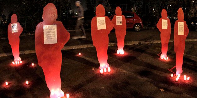 A man passes by cardboard silhouettes representing women killed as a result of domestic violence in Bucharest, Romania, Thursday, Nov. 25, 2010 during an event to mark the International Day for the Elimination of Violence against Women. Romania, an European Union member state, still has no proper legal framework to combat domestic violence against women, with police unable to intervene if acts of violence take place inside the couple's home.(AP Photo/Vadim Ghirda)