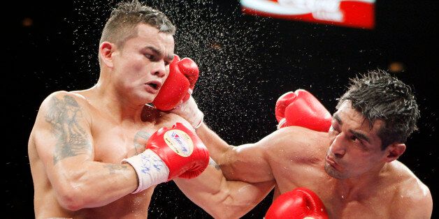 Erik Morales, of Mexico, right, punches Marcos Maidana, of Argentina during their WBA interim junior welterweight championship boxing match Saturday, April 9, 2011, in Las Vegas. Marcos Maidana won by majority decision. (AP Photo/Isaac Brekken)