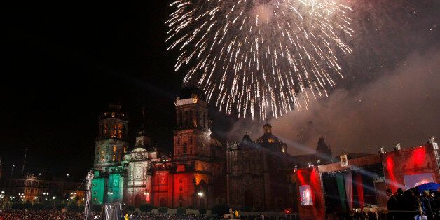 Fireworks explode over the Metropolitan Cathedral during the traditional "El grito," or the shout, to kick off Independence Day celebrations in the Zocalo in Mexico City, late Monday, Sept. 15, 2008. Mexico celebrates Independence Day on Sept. 16 which marks the anniversary of the beginning of Mexico's War of Independence with Spain (1810-1821). "El Grito" commemorates the call by Roman Catholic priest Miguel Hidalgo to his parishioners to rise up against Spanish colonial rule in 1810. (AP Photo/Gregory Bull)