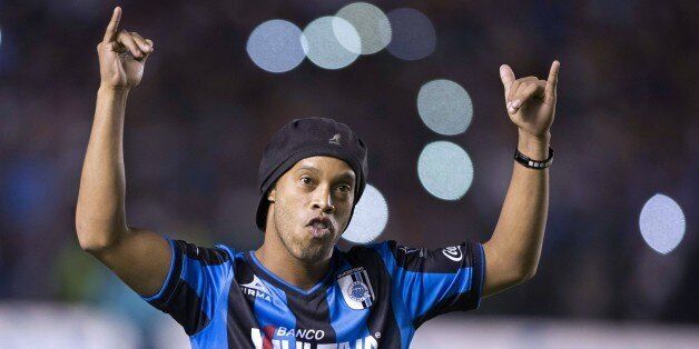 Queretaro's new footballer Ronaldo de Assis, better known as Ronaldinho, is introduced to the fans at The Corregidora Stadium, during the Mexican Apertura football tournament match against Puebla, in Queretaro, Mexico, on September 12, 2014. AFP PHOTO/ VICTOR STRAFFON (Photo credit should read VICTOR STRAFFON/AFP/Getty Images)