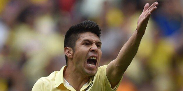America's forward Oribe Peralta gestures during their Mexican Apertura tournament football match against Pumas at the Azteca stadium in Mexico City on August 30, 2014. AFP PHOTO/ Yuri CORTEZ (Photo credit should read YURI CORTEZ/AFP/Getty Images)