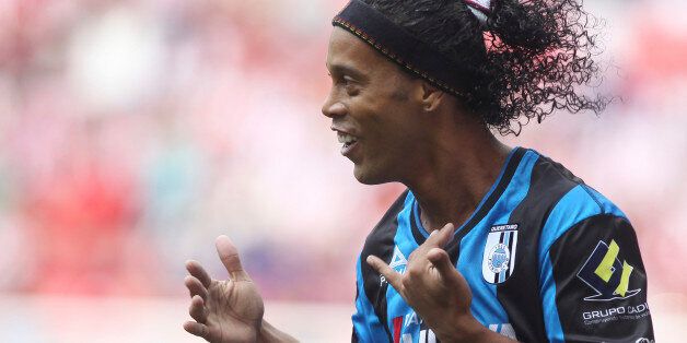 GUADALAJARA, MEXICO - SEPTEMBER 21: Ronaldinho of Queretaro celebrates after scoring the opening goal from the penalty spot during a match between Chivas and Queretaro as part of 9th round Apertura 2014 Liga MX at Omnilife Stadium on September 21, 2014 in Guadalajara, Mexico. (Photo by Refugio Ruiz/LatinContent/Getty Images)