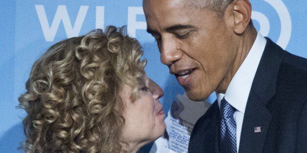 US President Barack Obama (R) hugs DNC Chair Rep. Debbie Wasserman Schultz, D-FL, as he arrives on stage to speak at the Democratic National Committee's Womens Leadership Forum Issues Conference in Washington, DC on September 19, 2014. According to a 'Politico' story, the party has lost in confidence in her. AFP PHOTO/Mandel NGAN (Photo credit should read MANDEL NGAN/AFP/Getty Images)