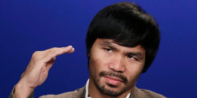 Boxer Manny Pacquiao gestures during an interview with The Associated Press, Friday, Sept. 5, 2014 in New York. Pacquiao takes on undefeated Chris Algieri in the gambling enclave of Macau on Nov. 22 for a piece of the welterweight title. The bout comes a year after the Filipino headlined the first big fight card there by beating Brandon Rios. (AP Photo/Mark Lennihan)