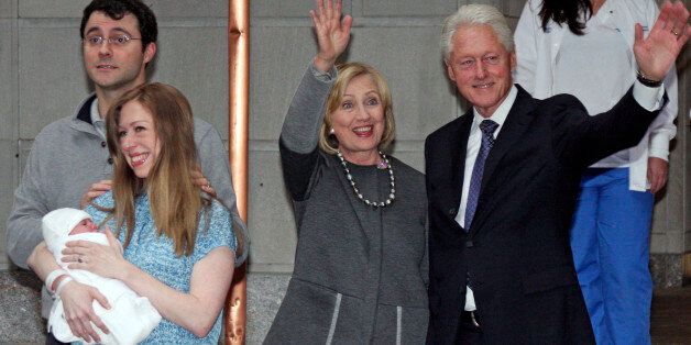 Former President Bill Clinton, right, and former Secretary of State Hillary Rodham Clinton, second from right, wave to the media as Marc Mezvinsky and Chelsea Clinton pose for photographers with their newborn baby, Charlotte, after the family leaves Manhattan's Lenox Hill hospital in New York, Monday, Sept. 29, 2014. (AP Photo/William Regan)