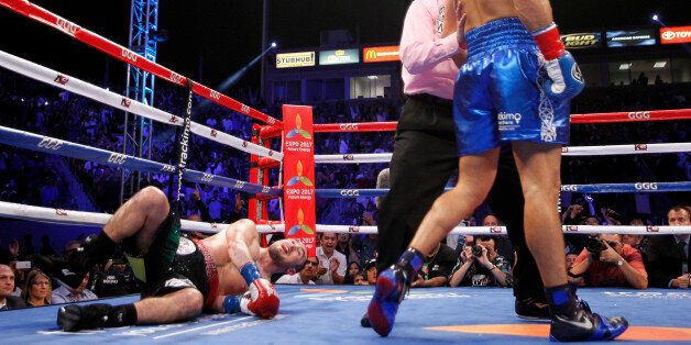 Gennady Golovkin, right, of Kazakhstan, is pushed to a corner by referee Jack Reiss after knocking down Marco Antonio Rubio during the second round during the WBC middleweight title boxing bout Saturday, Oct. 18, 2014, in Carson, Calif. Golovkin won when the fight was stopped in the second round. (AP Photo/Alex Gallardo)