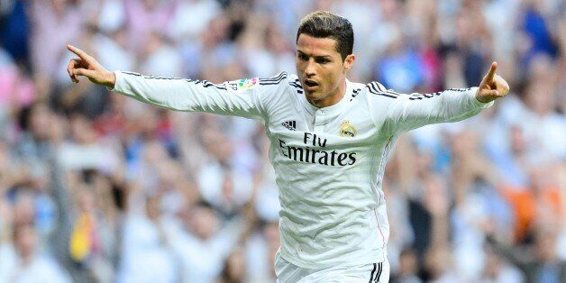 Real Madrid's Portuguese forward Cristiano Ronaldo celebrates after scoring during the Spanish league 'Clasico' football match Real Madrid CF vs FC Barcelona at the Santiago Bernabeu stadium in Madrid on October 25, 2014. AFP PHOTO / DANI POZO (Photo credit should read DANI POZO/AFP/Getty Images)