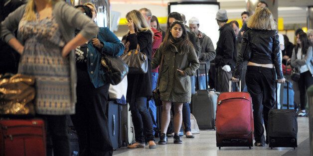 Travellers in a long check-in line caused by a computer malfunction at Spirit Airlines November 24, 2010 at La Guardia Airport in New York on what is considered the heaviest travel day of the year. AFP PHOTO/Stan Honda (Photo credit should read STAN HONDA/AFP/Getty Images)