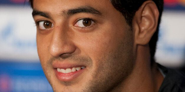 Real Sociedad's Carlos Vela smiles during a press conference at Manchester United's Old Trafford Stadium, Manchester, England, Tuesday, Oct. 22, 2013. Real Sociedad will play Manchester United in a Champion's League Group A soccer match on Wednesday. (AP Photo/Jon Super)