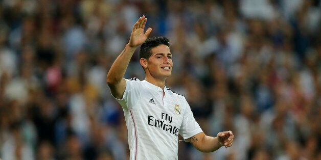 Real Madrid's James Rodriguez signals during a Spanish La Liga soccer match between Real Madrid and Barcelona at the Santiago Bernabeu stadium in Madrid, Spain, Saturday Oct. 25, 2014. (AP Photo/Paul White)