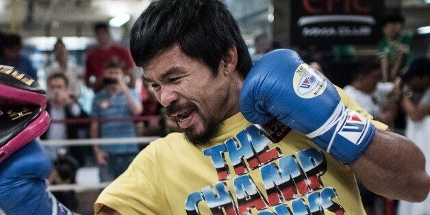 Philippine boxing icon Manny Pacquiao (R) takes part in a sparring session during a media call in Hong Kong on October 27, 2014. Pacquiao is touring Hong Kong ahead of his World Boxing Organization title defence against undefeated Chris Algieri of the US, to be held in Macau on November 22. AFP PHOTO / Philippe Lopez (Photo credit should read PHILIPPE LOPEZ/AFP/Getty Images)